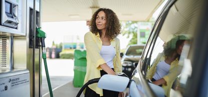 A woman fuelling her car