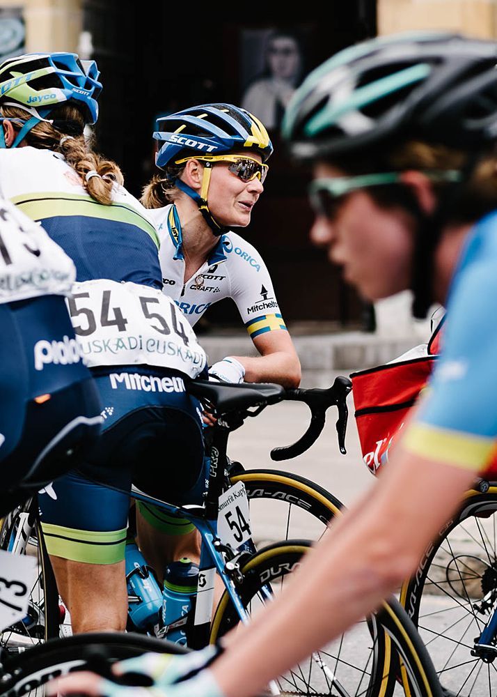 Stage winner Emma Johansson (Orica-AIS) catches her breath as the rest of the peloton come through the finish