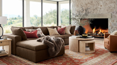 a cozy living room with a large brown sectional and a nesting coffee table