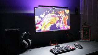 A desk setup illuminated at night by the Quntis RGB Pro+ monitor light bar