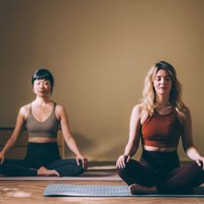 Two woman doing the best low impact exercises in a yoga studio