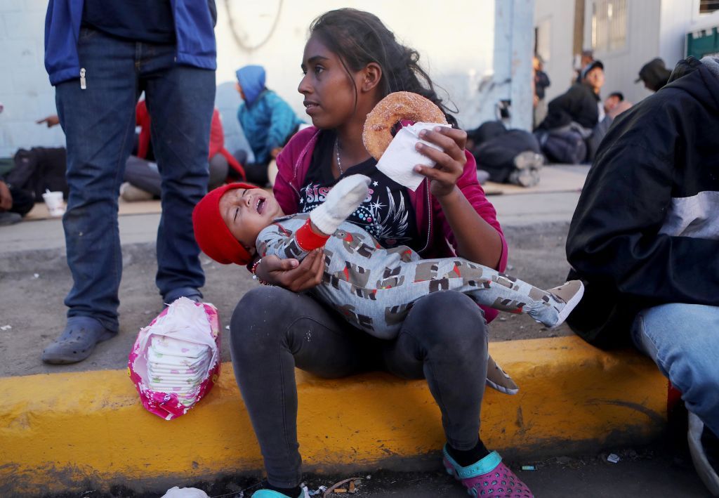 Migrants gather outside a temporary shelter set up for members of the &amp;#039;migrant caravan&amp;#039; on November 24, 2018 in Tijuana, Mexico. 