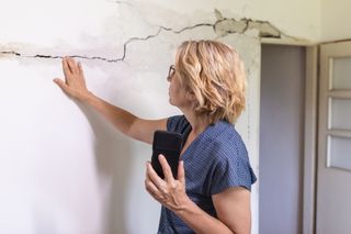 Woman documenting damage from tornado inside her home.