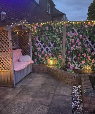 a garden patio scene with a seated arbour and shower curtain with rose trellis motif detail
