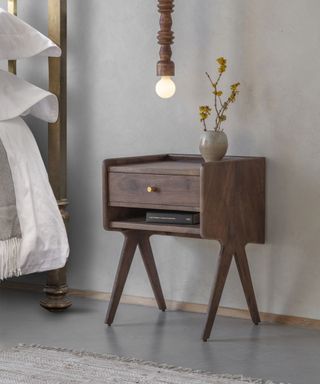 Wooden bedside table with hanging light