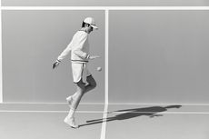 Woman on tennis court in Brunello Cucinelli tennis fashion photographed in black and white