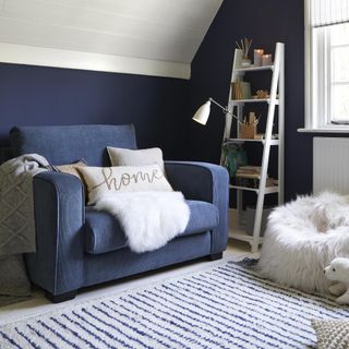 snug with blue sofa and striped rug