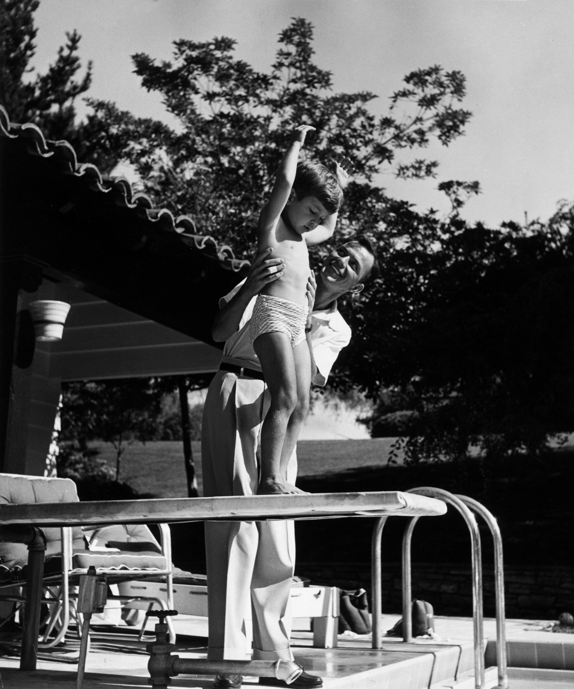 frank sinatra with his son frank jr on the diving board