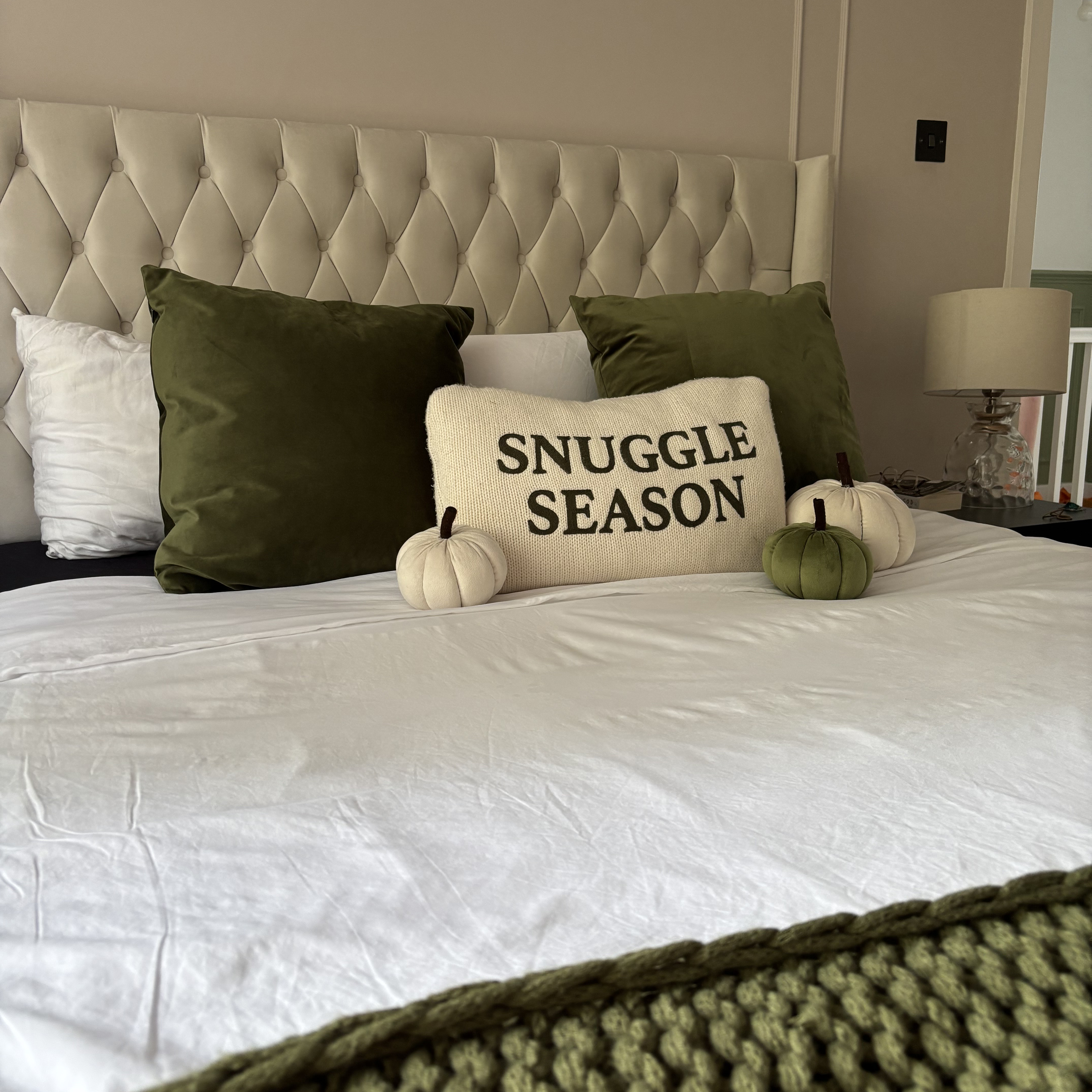 bed with cushions in the shape of pumpkins on it