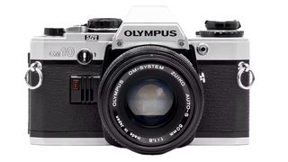 Front view of an Olympus OM-10 camera with a black body, silver accents, and a Zuiko 50mm lens, showcasing classic design features