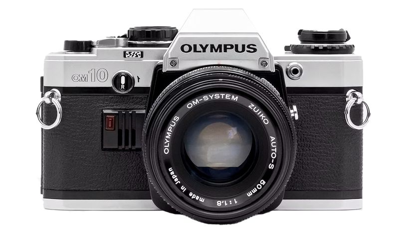 Front view of an Olympus OM-10 camera with a black body, silver accents, and a Zuiko 50mm lens, showcasing classic design features
