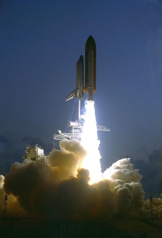 Space shuttle Endeavour lifts off to begin its first mission, STS-49, on May 7, 1992. The shuttle would rendezvous with a stranded communications satellite and return it to service.