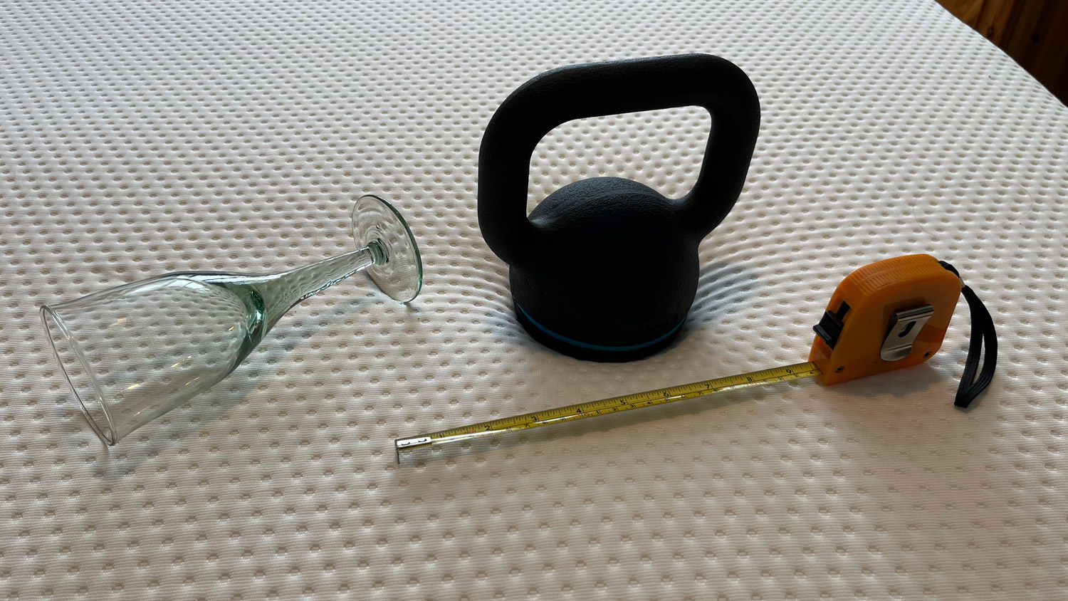 A wine glass, kettlebell and tape measure on the Emma NextGen Premium