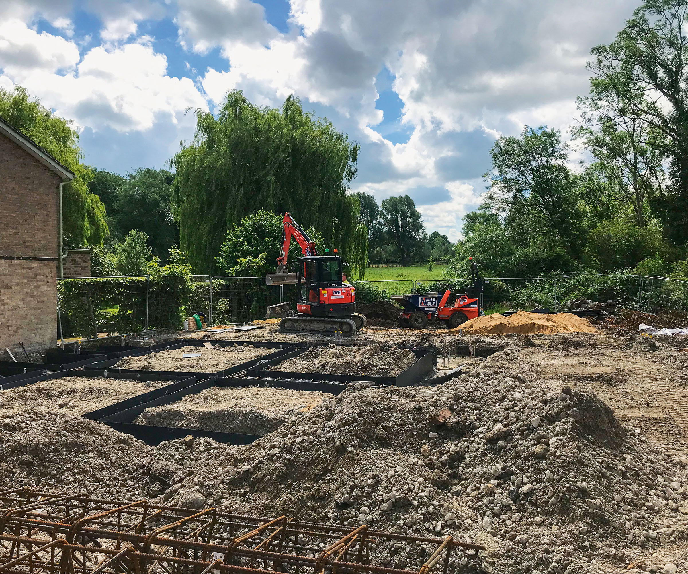 Digger being operated to level out the ground ready for a self build home to be built