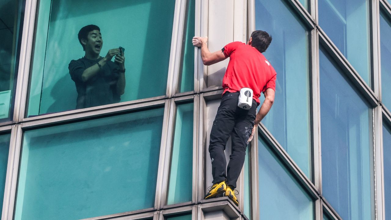 Climber Alex Honnold free-scales the Taipei 101 tower in Taiwan.