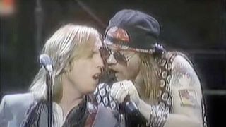 Axl Rose and Tom Petty sharing a mic at the MTV Awards