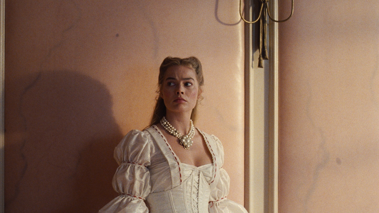 Margot Robbie's Cathy looking at skin walls in Wuthering Heights