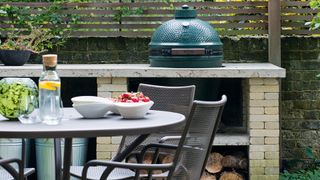 Outdoor kitchen area with dining table and Green egg BBQ