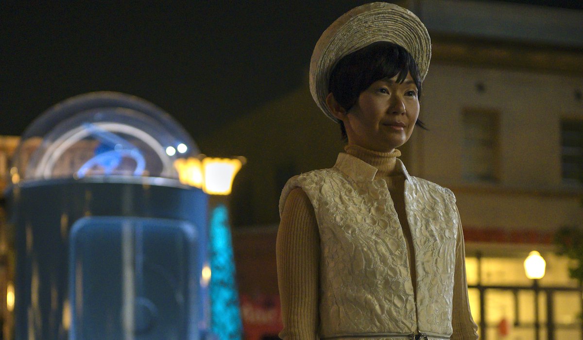 lady trieu in front of doctor manhattan phone booth