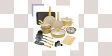 cookware set with pots, pans, utensils, a cutting board, and a sheet pan in light yellow
