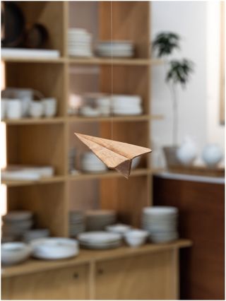 suspended paper plane in store