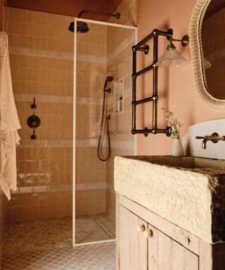 DIY small bathroom ideas, coral painted bathroom with walk in shower, glass doors, towel radiator on wall, wood vanity unit