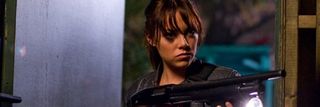 Emma Stone holding a shotgun in Zombieland