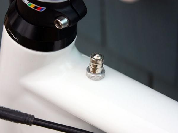A discreet Schrader valve mounted on the top tube just aft of the head tube is the only visual cue that the frame is pressurized.