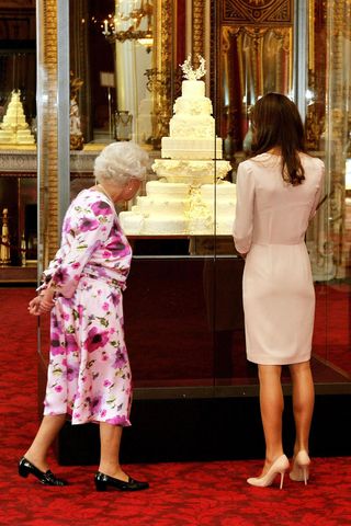 Kate Middleton And The Queen Viewing The Royal Wedding Cake