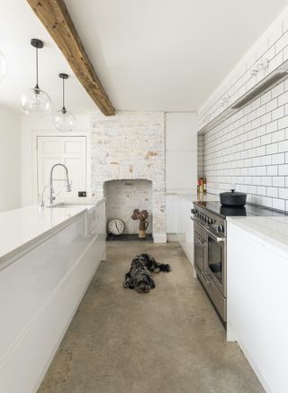 white kitchen with whitewashed empty fireplace