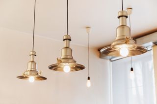 Rustic gold metal lighting hanging from ceiling.