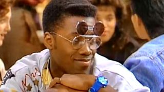 Kadeem Hardison as Dwayne Wayne, wearing his signature glasses and smiling