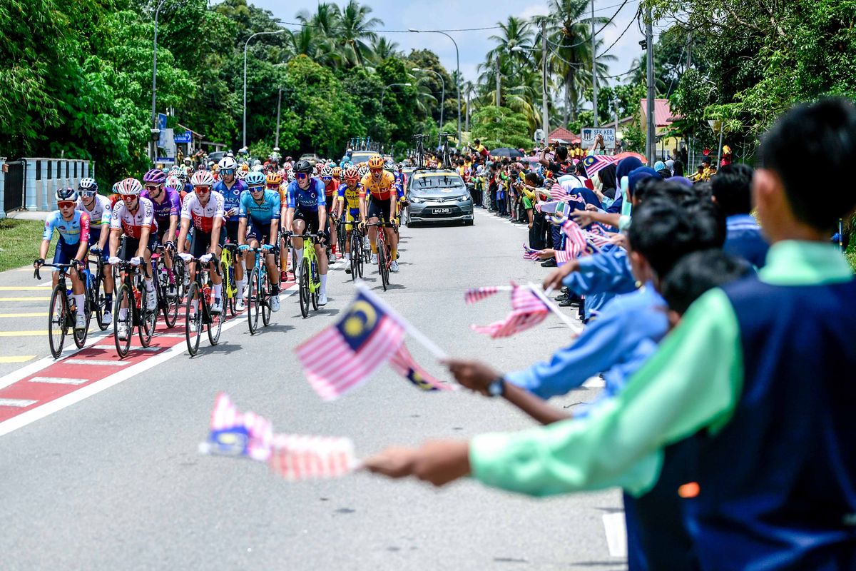 Crowds cheering on the riders as they go past on stage 1 of Petronas Le Tour de Langkawi 2022