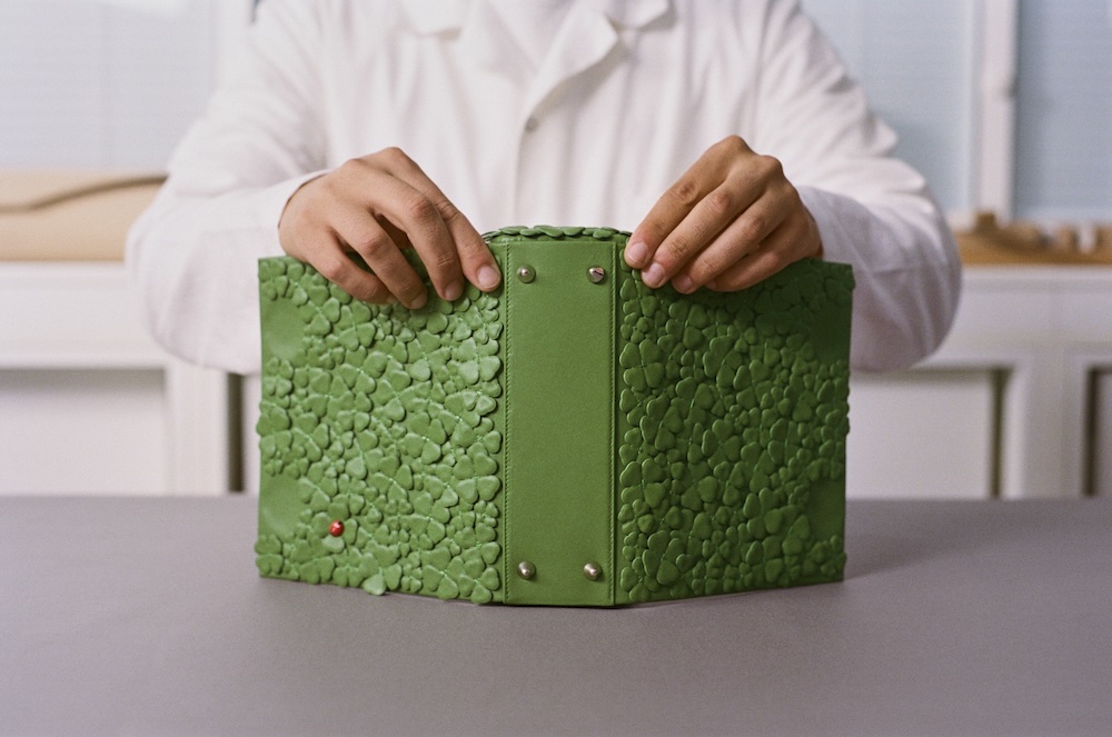 a Dior craftsman assembling a Dior clover bag