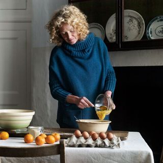 Kate Humble making a cake with eggs and oranges in a country kitchen
