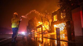 A firefighter battles the Palisades Fire in Los Angeles. 