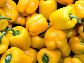 A pile of yellow peppers