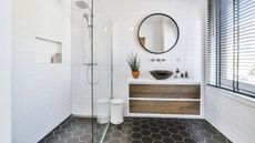 Small white bathroom with black tile floor