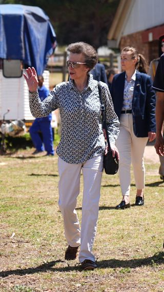 The Princess Royal waves during a visit to the South African Riding School for Disabled Association (SARDA)