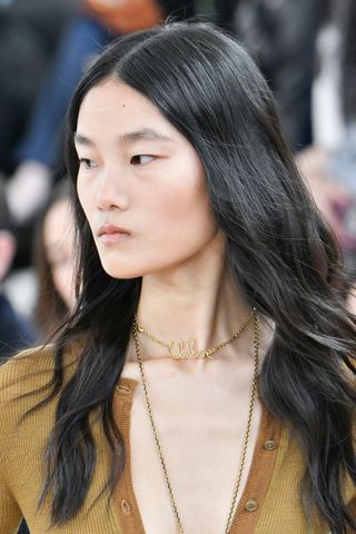 Chloé AW24 model with the bare-faced make-up trend