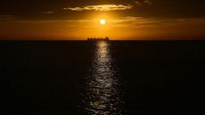 An oil vessel is silhouetted at sunset in the Caribbean Sea, near Santa Marta, Colombia