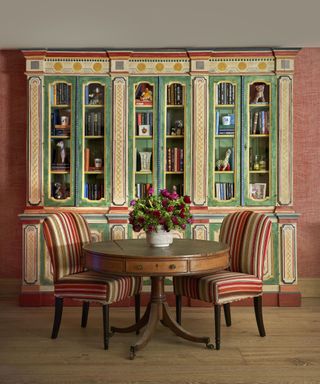 Red dining room with painted green shelving