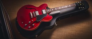 Epiphone Inspired By Gibson Custom 1962 ES-335 Reissue: the handsome semi-hollow electric is finished in Sixties Cherry and is photographed against various backgrounds.