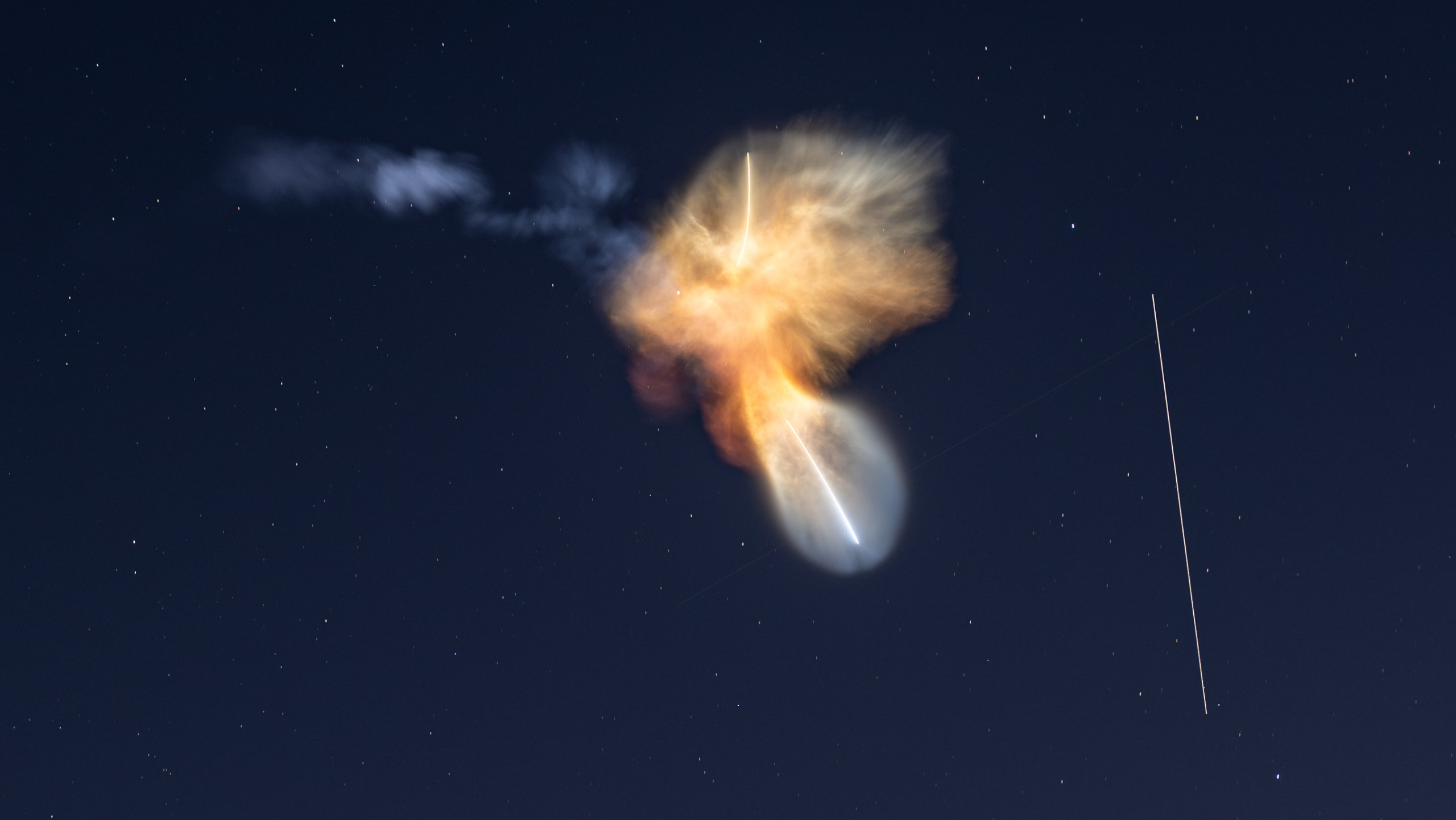 Sunlight hitting exhaust plumes from a SpaceX rocket creates an unusual shape in the sky