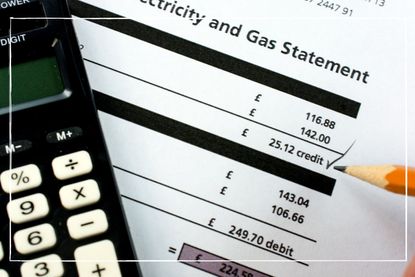 close up of a gas and electricity bill with a calculator on top