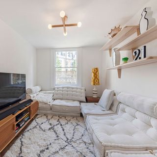 snug area with table lamp and tv