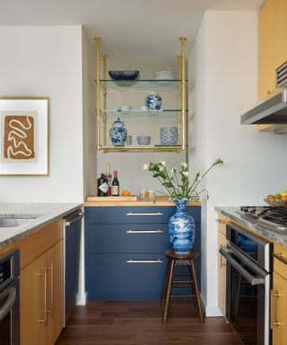 kitchen with white walls and dark blue lower cabinets