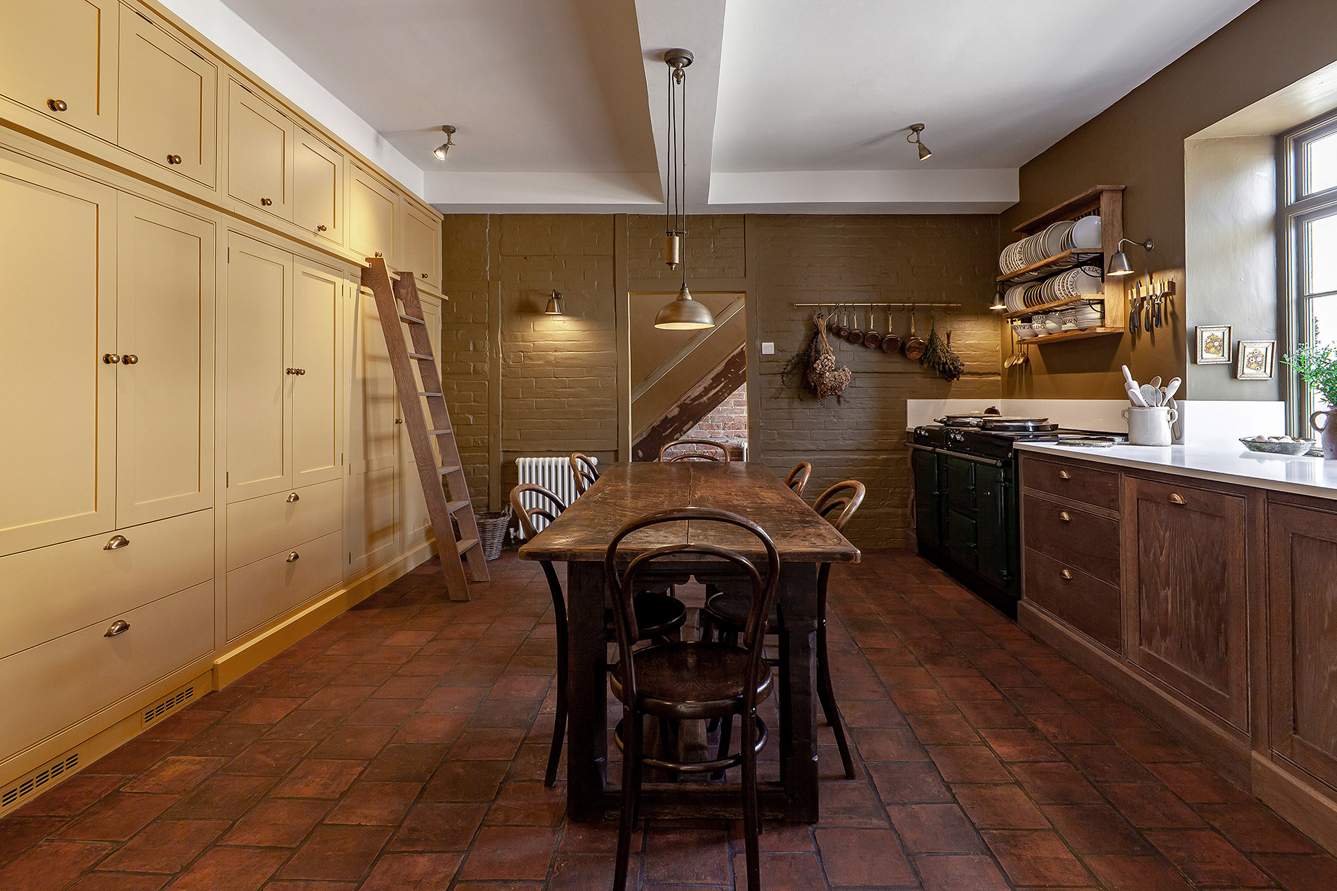 kitchen with built in yellow floor to ceiling cabinets along with rustic kitchen cabinetry