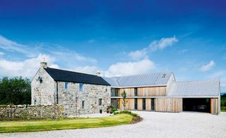 Wayne and Lorrie Bilsborrow have transformed their granite farmhouse with the addition of a contemporary timber extension