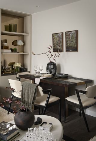 dining room with black dining table and pale walls